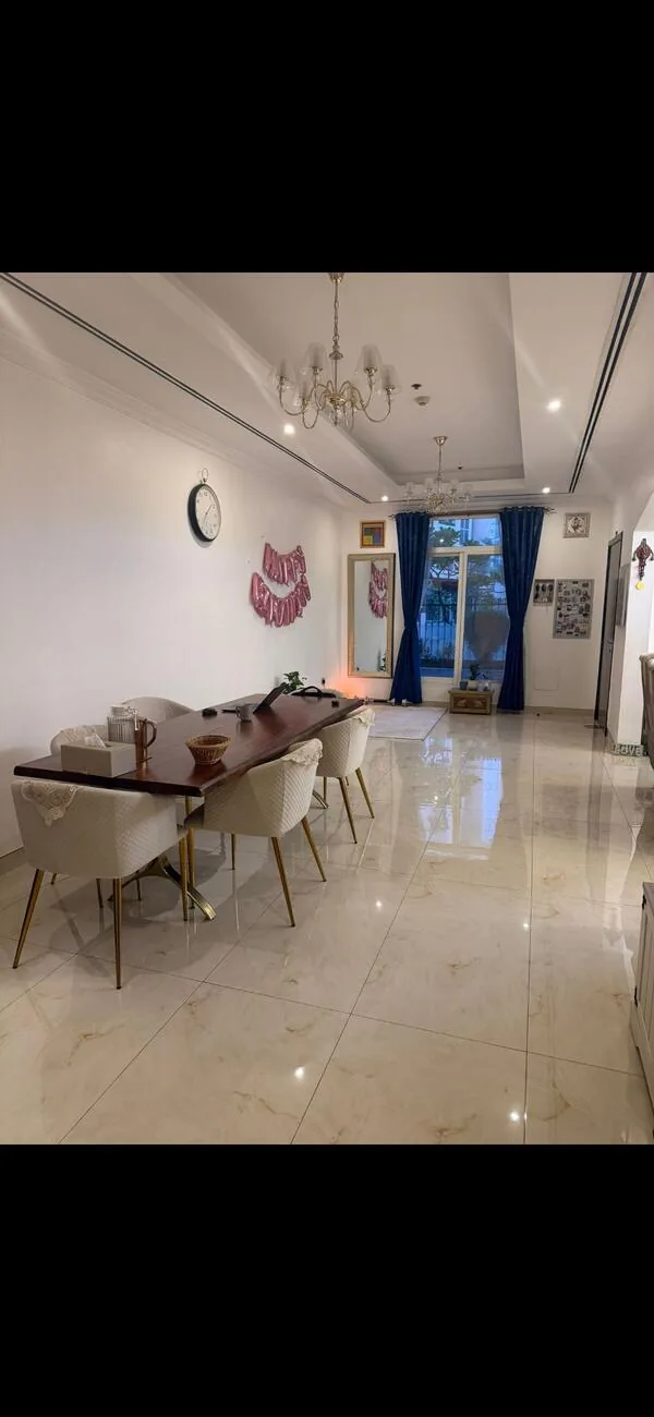 Dining room before — bare reception with mismatched furniture