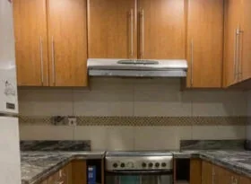 Kitchen before — dated oak cabinets
