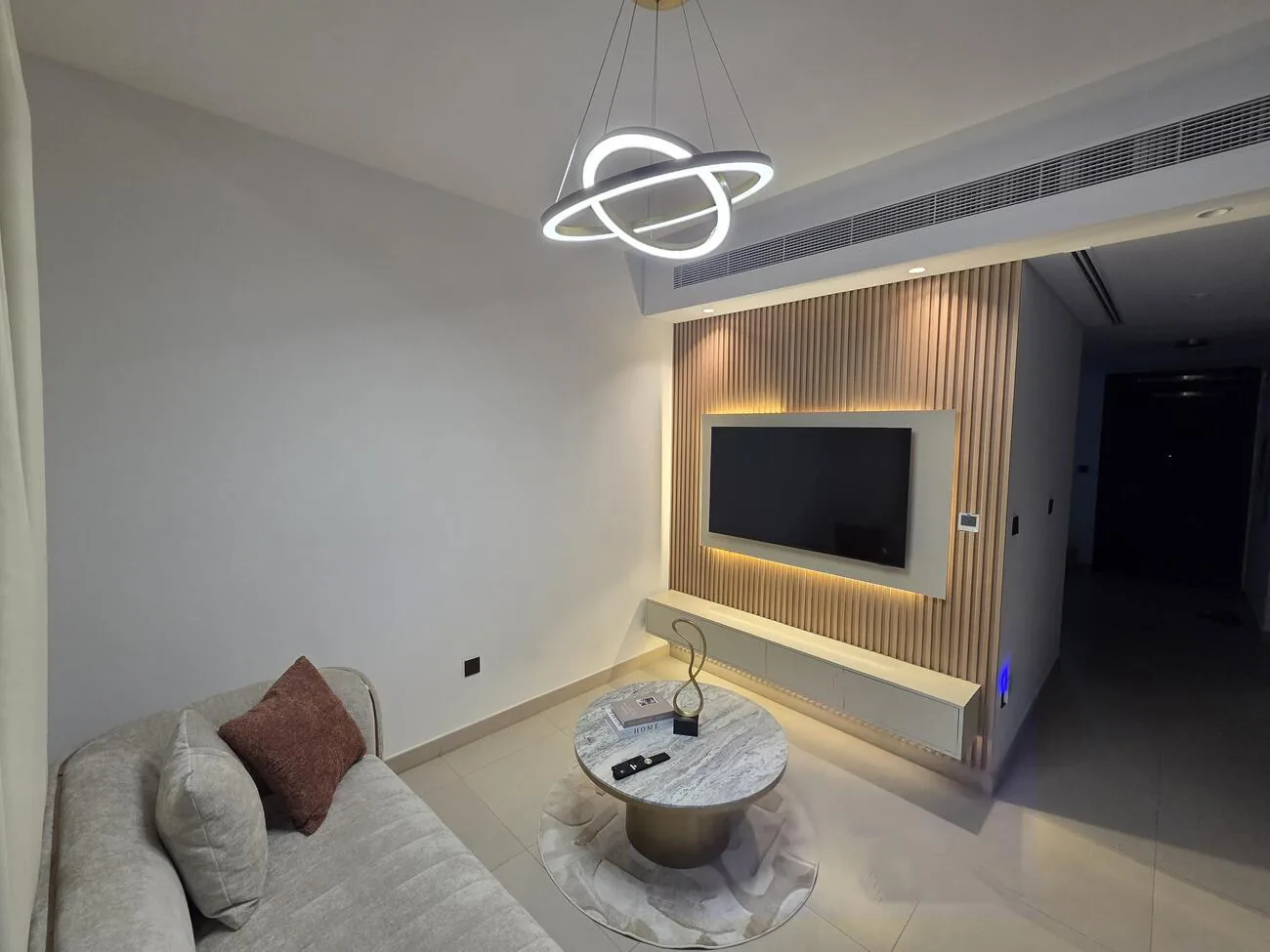 Fluted oak media wall with concealed lighting — KeyReady Homes Dubai project